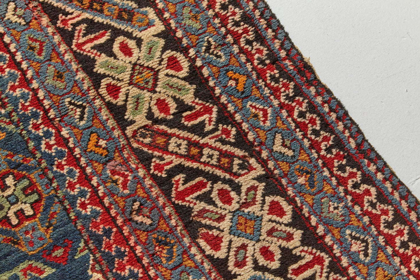 Border detail from Chi chi antique Persian Rug runner with blue, red and cream designs intricately hand woven throughout, perfect for a hallway, living room or study - Available from King Kennedy Rugs Los Angeles