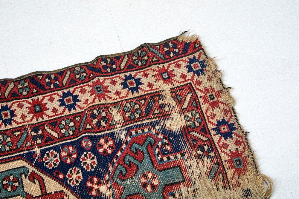 Intricate hand woven Kazak red, cream, dark blue and green Persian area rug - available from King Kennedy Rugs Los Angeles