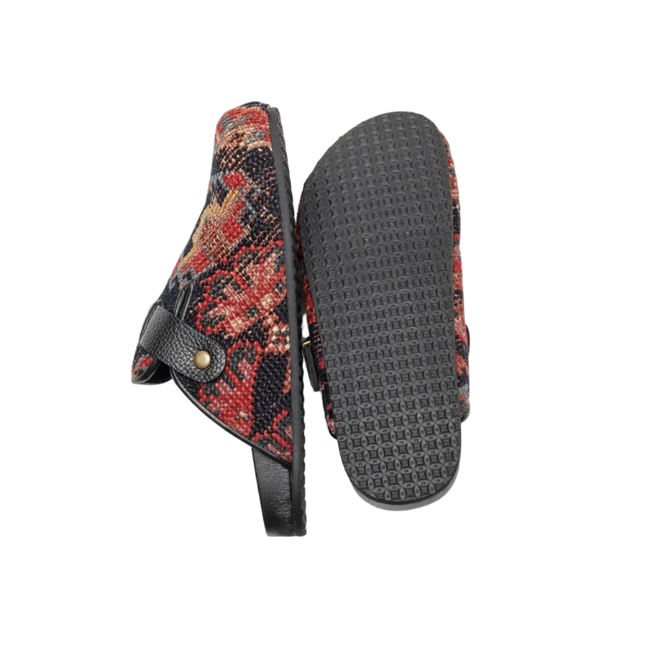 Side and rubber sole view of rug mules. King Kennedy Rug Mules are one-of-a-kind and made of 100 year old antique Persian rug fragments with soft lambskin footbed and comfortable rubber sole. This pair is made of an antique Persian rug with dark blue base, and red, blue and gold floral motifs.