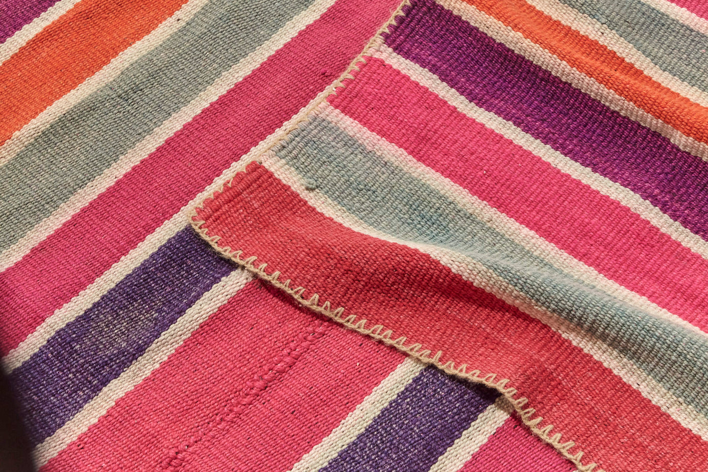 Guatemalan vintage rug with vibrant red, pink, purple and cream stripes, would be perfect for a bedroom, nursery or living room rug - Available from King Kennedy Rugs Los Angeles