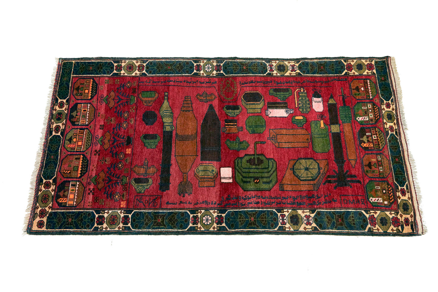 Afghan hand woven "Unexploded Ordinance" rug, with deep red base, and green, yellow, tan and cream images depicting weapons, buildings and flowers - Available from King Kennedy Rugs Los Angeles
