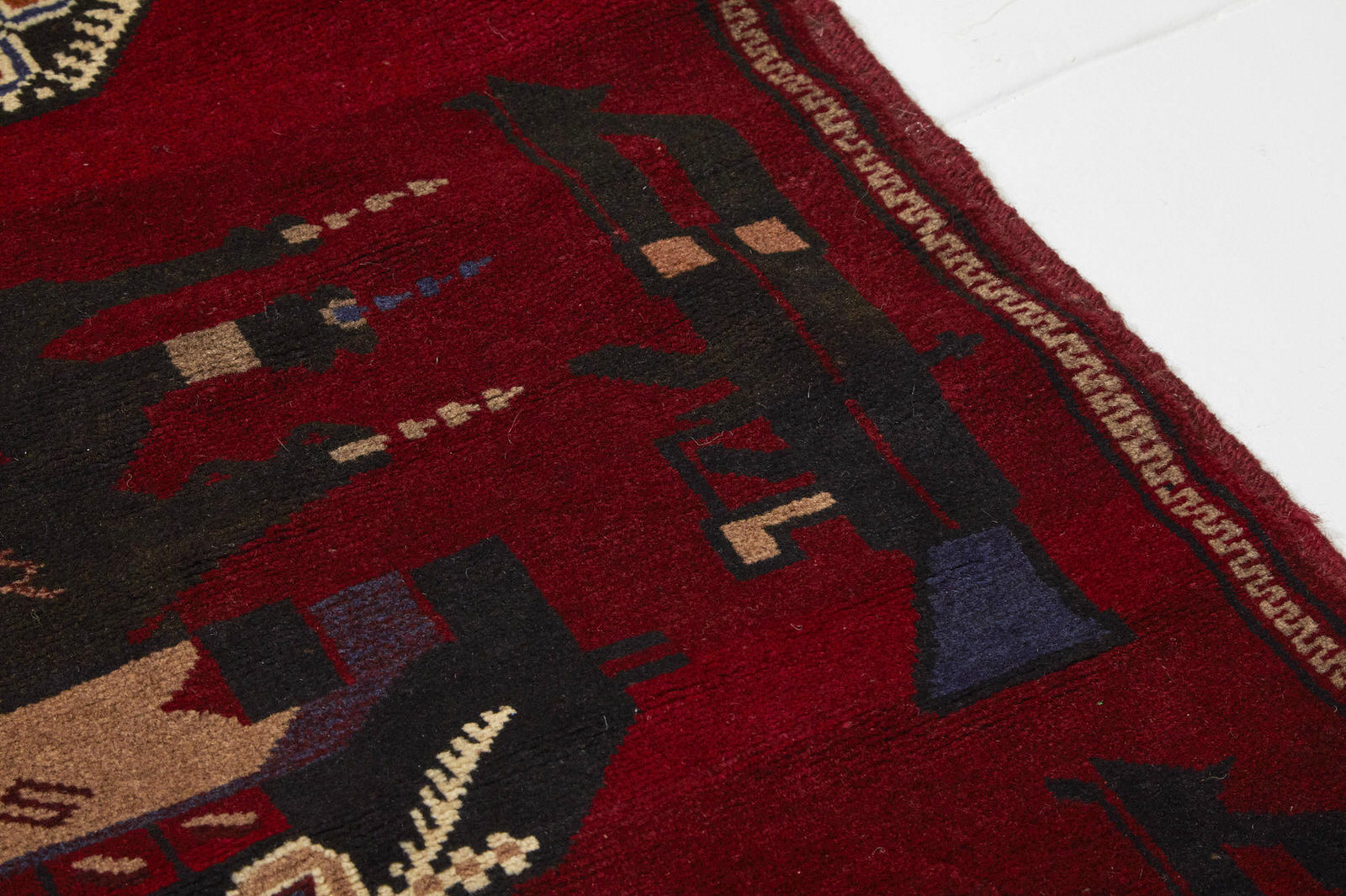 Red hand woven Afghan War Rug with red base and blue, brown, cream and tan tanks and weapons - Available from King Kennedy Rugs Los Angeles
