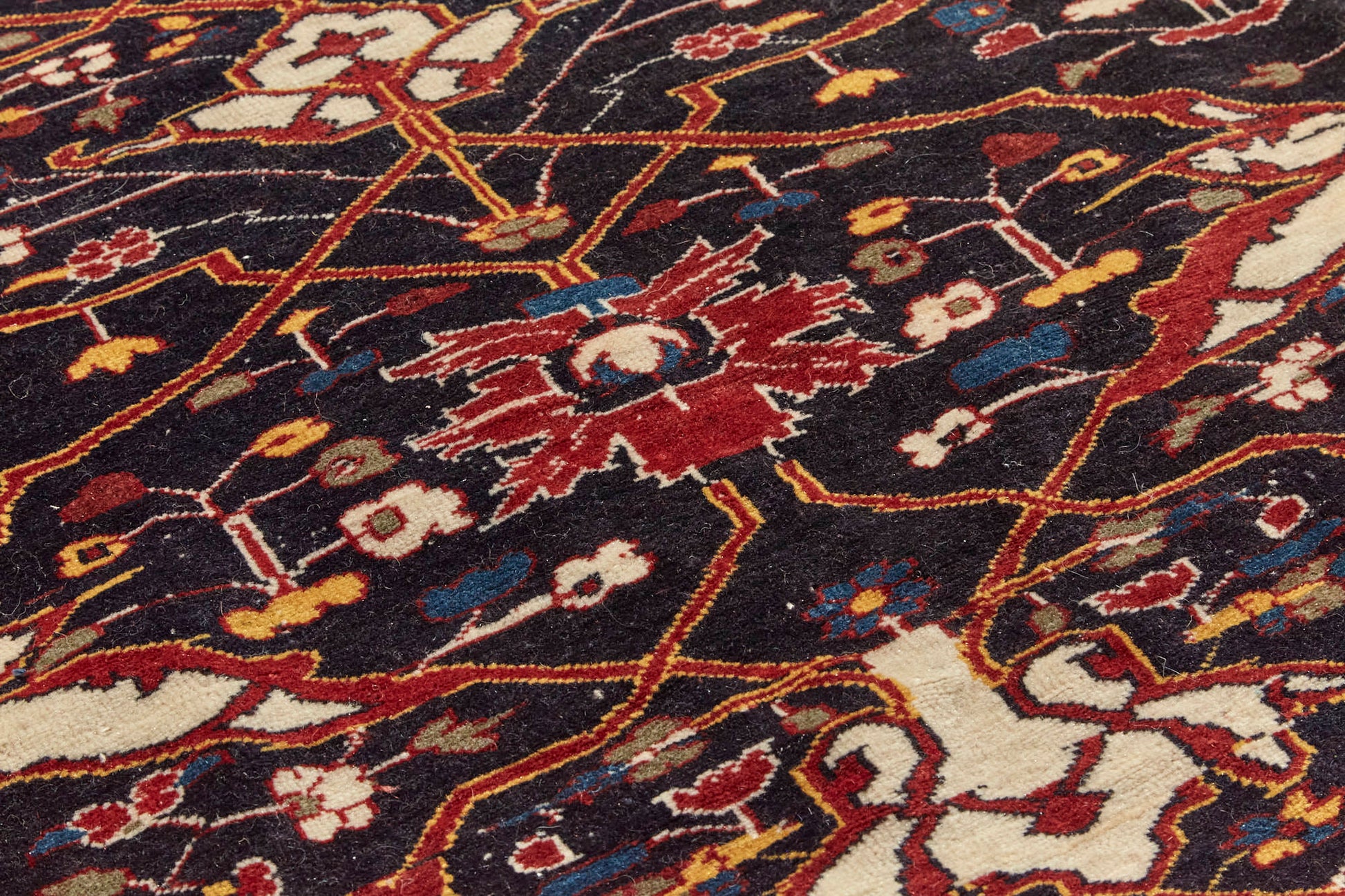 Detail of antique Bidjar Persian Rug Sampler, hand woven with dark blue base and red, cream, gold and lighter blue shapes, beautiful piece in excellent condition for a study, bedroom or foyer rug - Available from King Kennedy Rugs Los Angeles