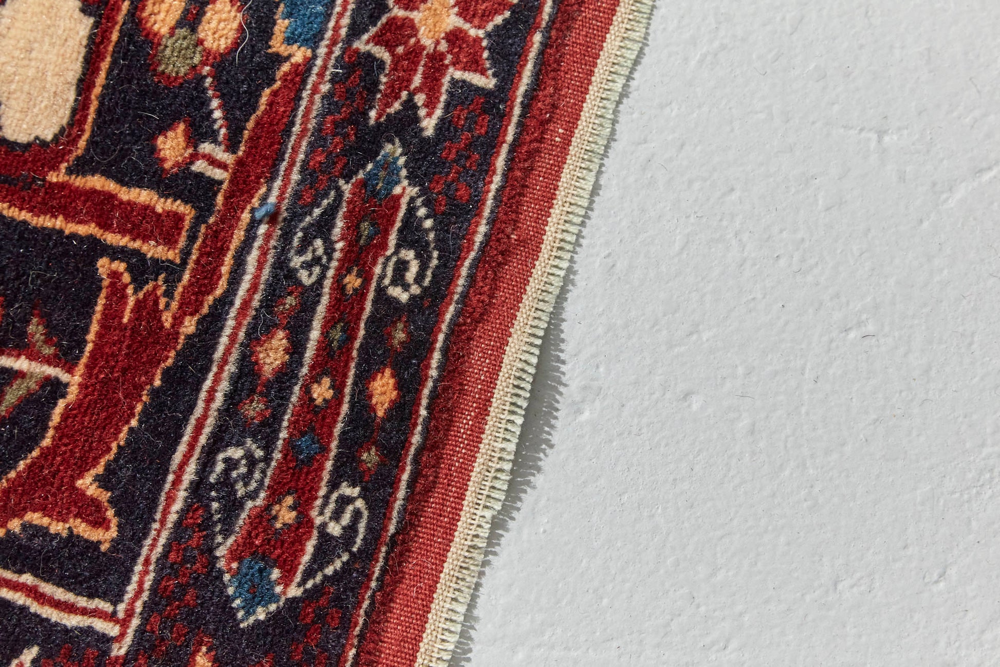 Border detail of Antique Bidjar Persian Rug Sampler, hand woven with dark blue base and red, cream, gold and lighter blue shapes, beautiful piece in excellent condition for a study, bedroom or foyer rug - Available from King Kennedy Rugs Los Angeles