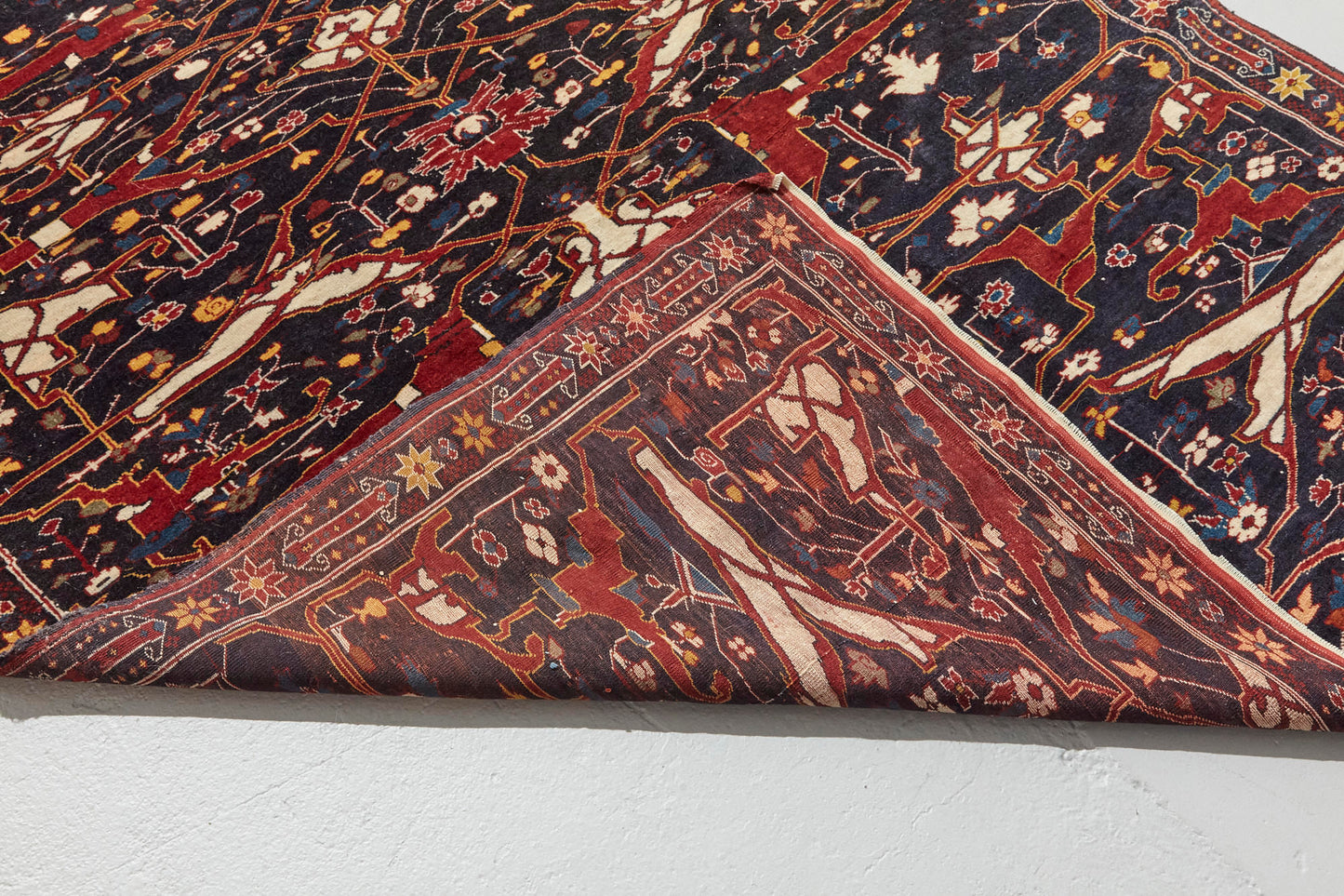 Front and back of Antique Bidjar Persian Rug Sampler, hand woven with dark blue base and red, cream, gold and lighter blue shapes, beautiful piece in excellent condition for a study, bedroom or foyer rug - Available from King Kennedy Rugs Los Angeles