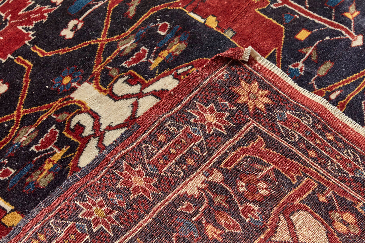 Front and back of Antique Bidjar Persian Rug Sampler, hand woven with dark blue base and red, cream, gold and lighter blue shapes, beautiful piece in excellent condition for a study, bedroom or foyer rug - Available from King Kennedy Rugs Los Angeles