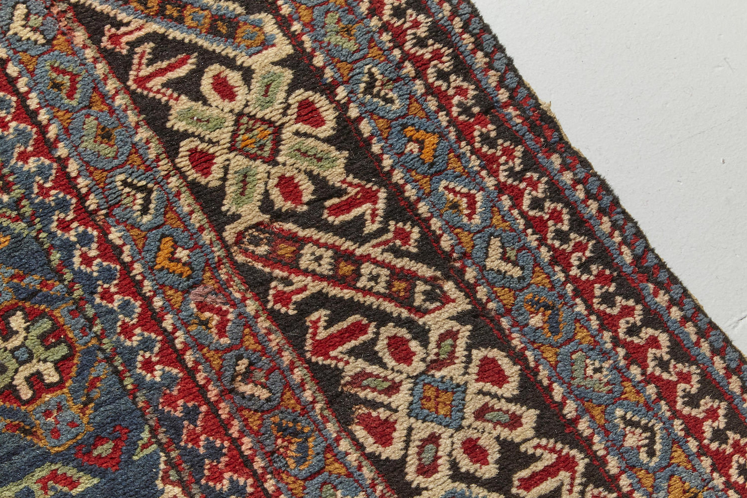 Border detail from Chi chi antique Persian Rug runner with blue, red and cream designs intricately hand woven throughout, perfect for a hallway, living room or study - Available from King Kennedy Rugs Los Angeles