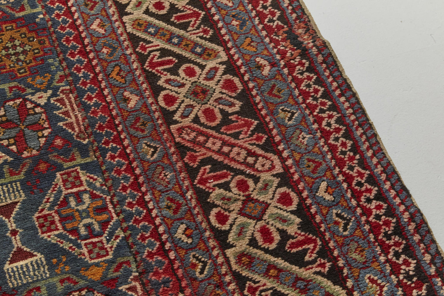 Border detail of Chi chi antique Persian Rug runner with blue, red and cream designs intricately hand woven throughout, perfect for a hallway, living room or study - Available from King Kennedy Rugs Los Angeles