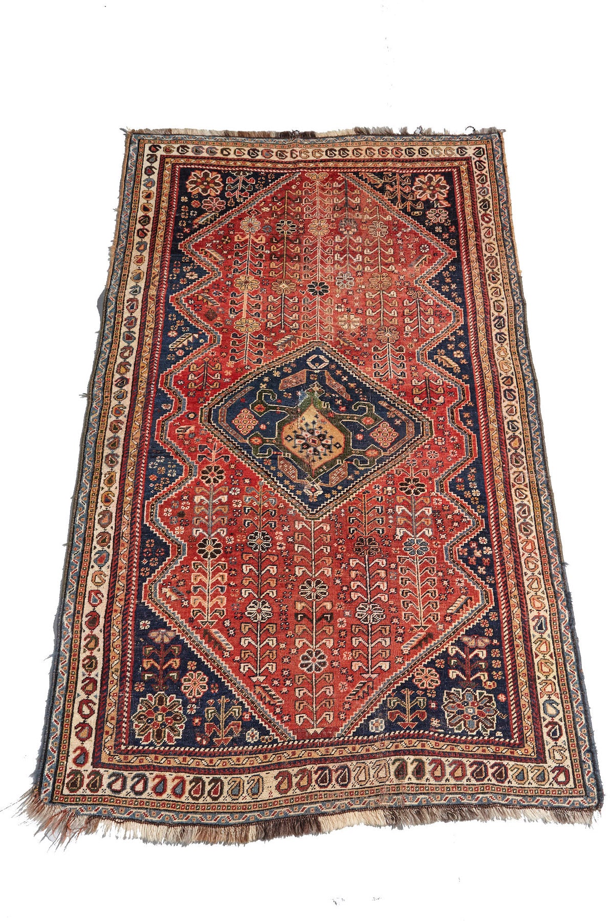 Kashkai antique Persian rug with red base, cream border and deep blue details. Plants and flowers woven throughout. Perfect for a bedroom or study.Available from King Kennedy Rugs Los Angeles