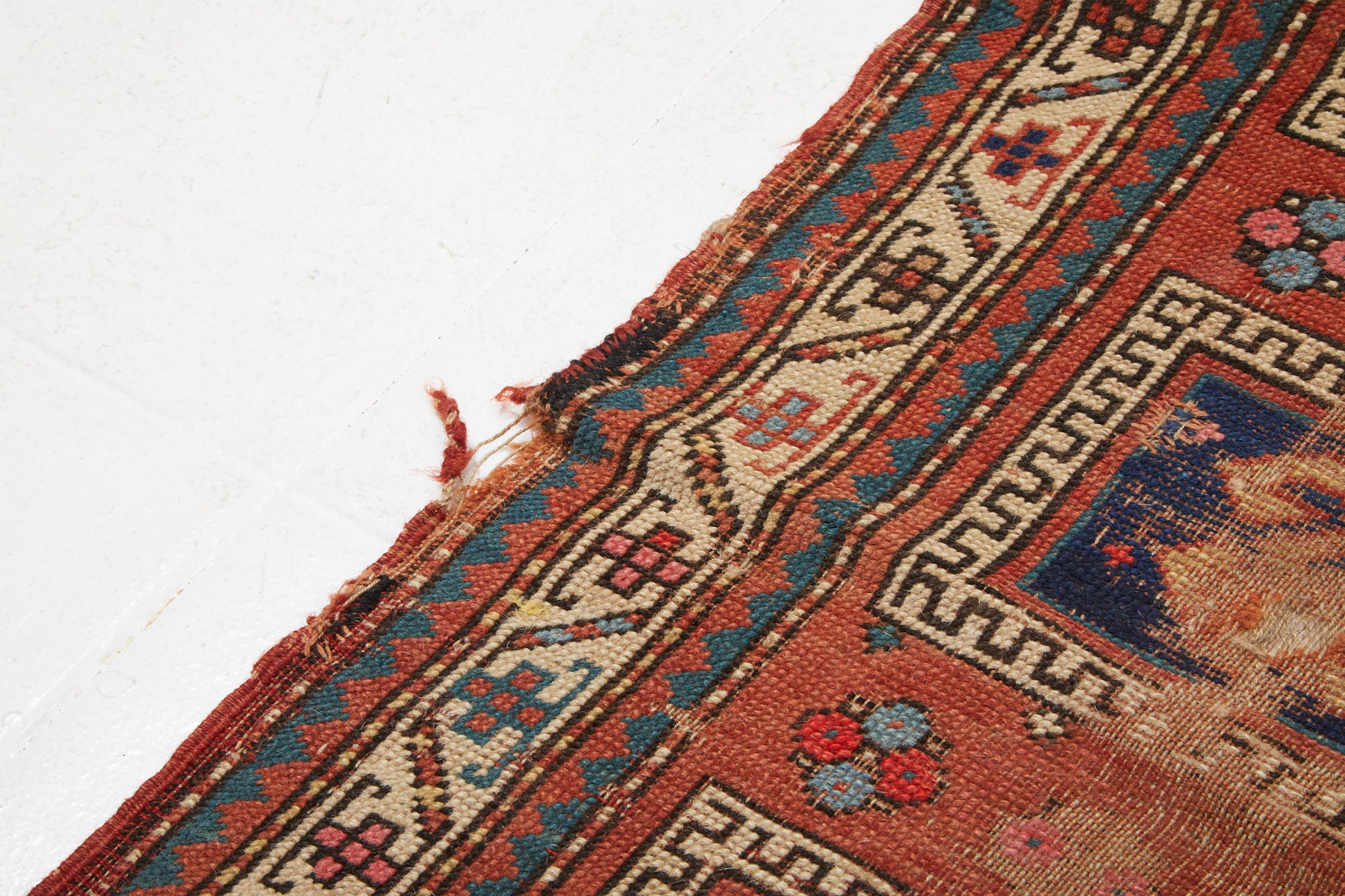 Antique Persian Kazak Prayer rug with pink red base and blue and cream designs - Available from King Kennedy Rugs Los Angeles