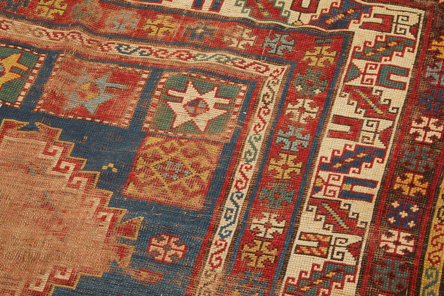 Hand woven antique Kazak Persian Rug - Blue base with red, cream and gold border - Available from King Kennedy Rugs Los Angeles