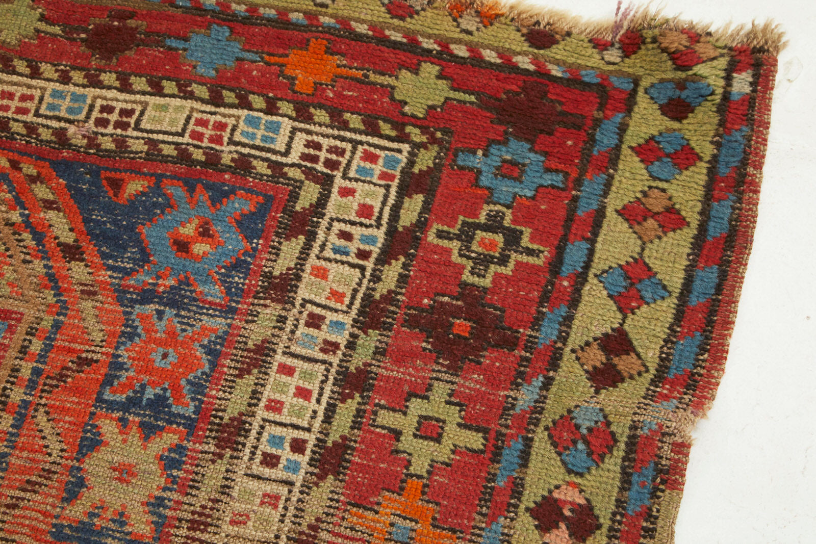 Border detail of Kazak Persian Caucasian Rug with red, brown, blue and orange colors vailable from King Kennedy Rugs Los Angeles 