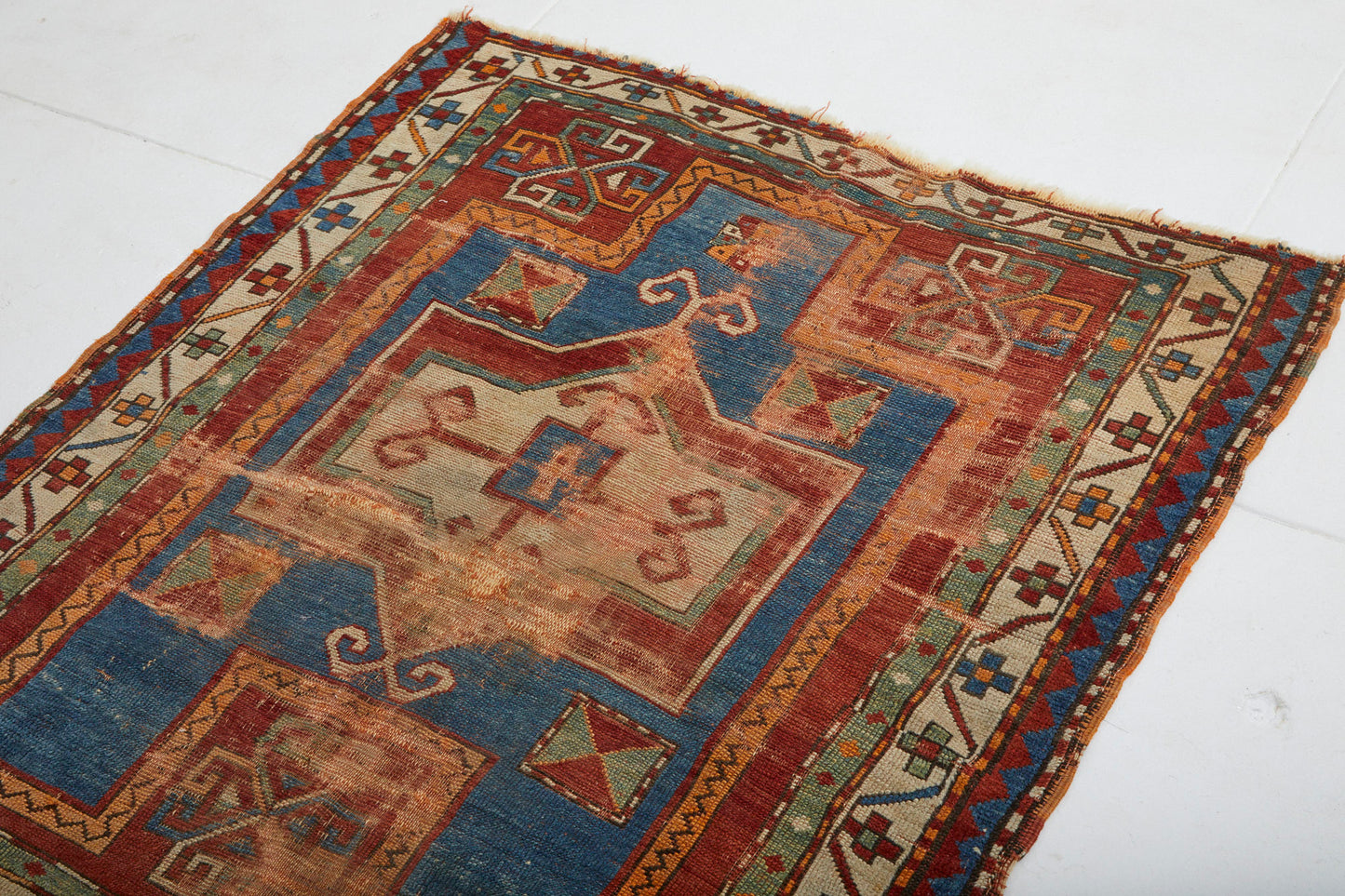 Antique hand woven Kazak Persian Rug with red, tan, blue and cream colors - Available from King Kennedy Rugs Los Angeles