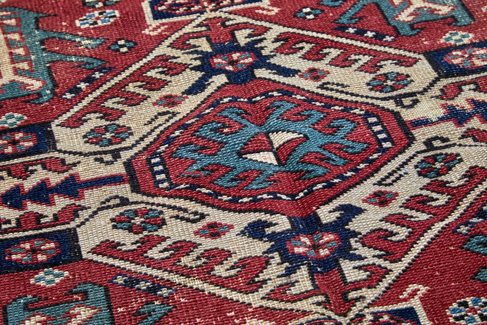 Intricate handwoven Kazak red, cream, dark blue and green Persian area rug - available from King Kennedy Rugs Los Angeles