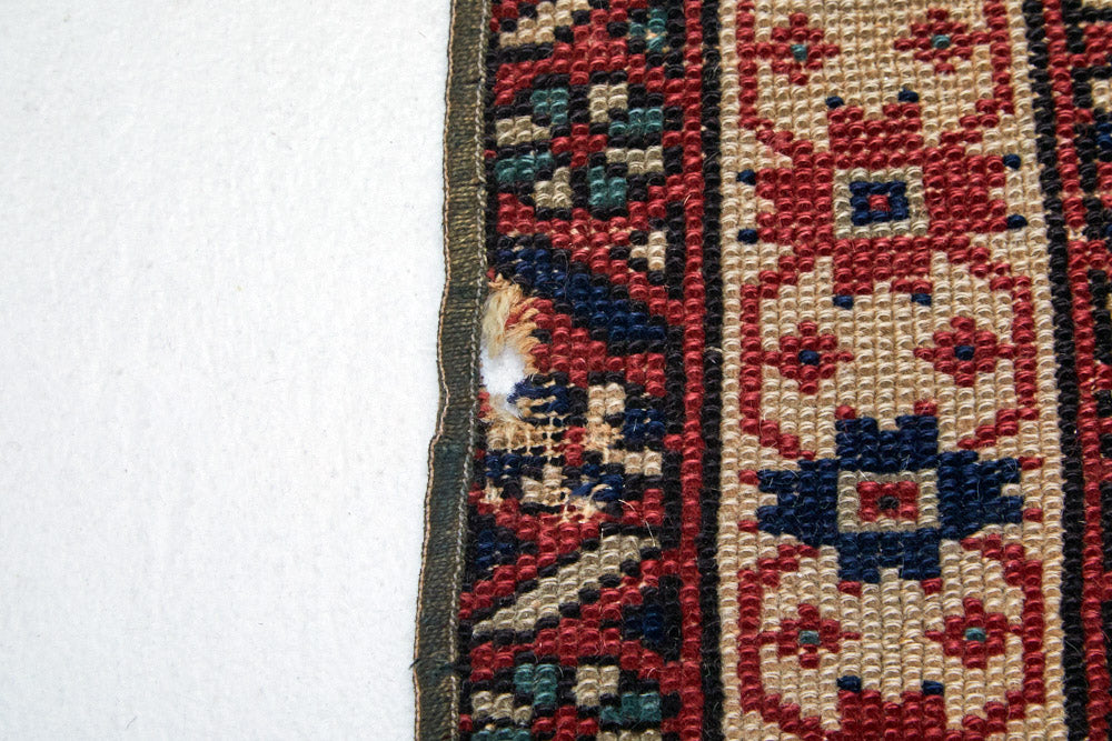 Detail of border of intricate hand woven Kazak red, cream, dark blue and green Persian area rug - available from King Kennedy Rugs Los Angeles