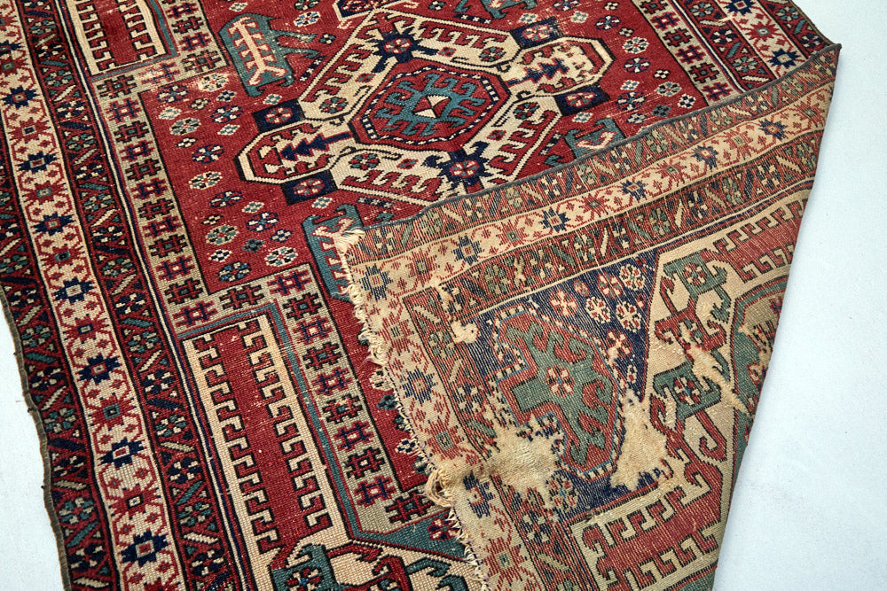 Intricate hand woven Kazak red, cream, dark blue and green Persian area rug - available from King Kennedy Rugs Los Angeles