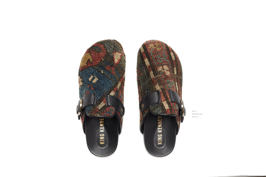 King Kennedy Rug Mules are one-of-a-kind and made of 100 year old antique Persian rug fragments with soft lambskin footbed and comfortable rubber sole. This pair is made of an antique Persian rug with blue, faded red and cream patterns. 