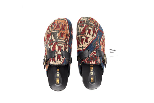 King Kennedy Rug Mules are one-of-a-kind and made of 100 year old antique Persian rug fragments with soft lambskin footbed and comfortable rubber sole. This pair is made of an antique Persian rug with blue base and cream, tan, red and grey medallion pattern. 