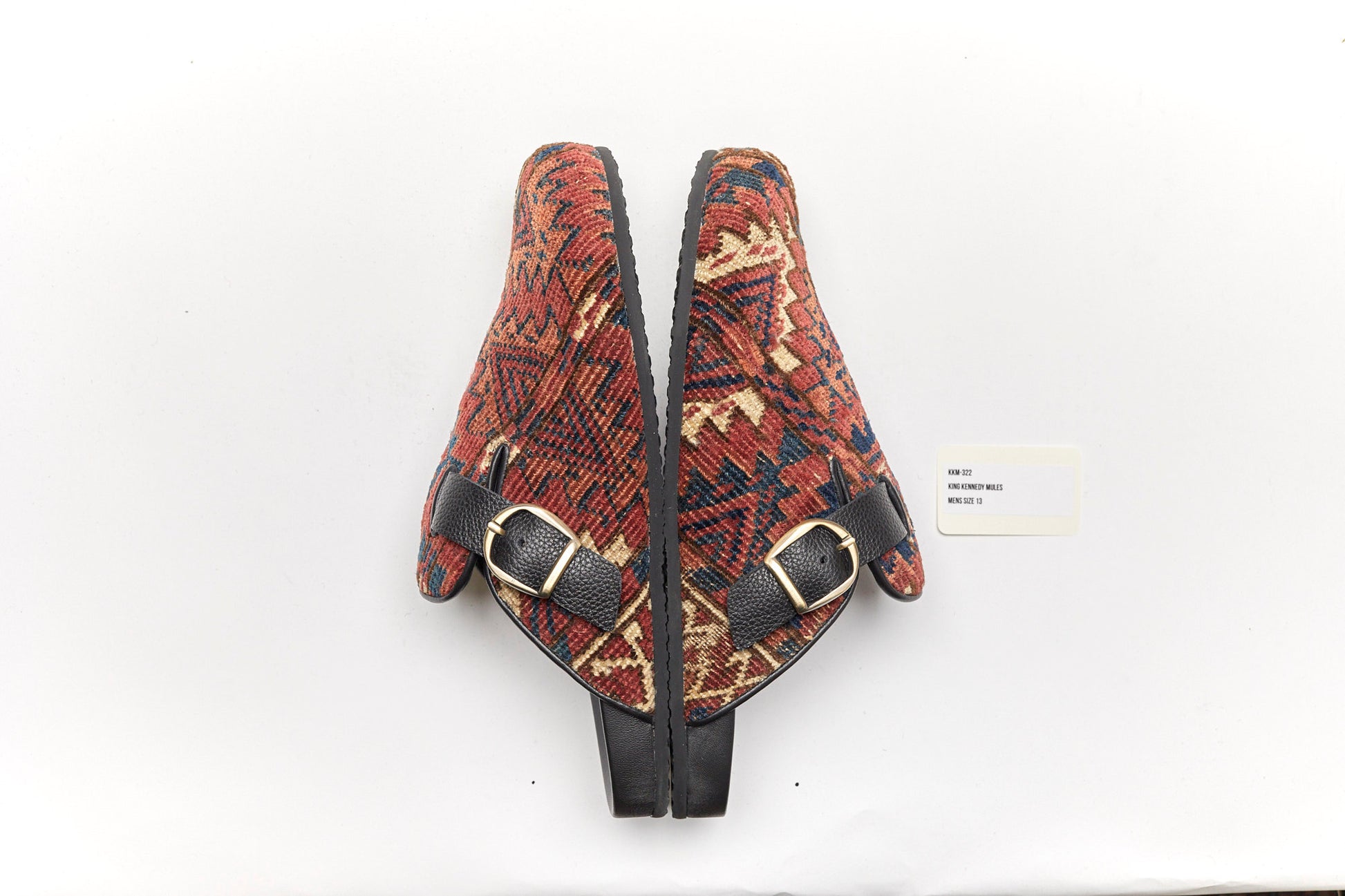 King Kennedy Rug Mules are one-of-a-kind and made of 100 year old antique Persian rug fragments with soft lambskin footbed and comfortable rubber sole. This pair is made of an antique Persian rug with a beautifully faded red base, cream, blue and amber design motifs.  