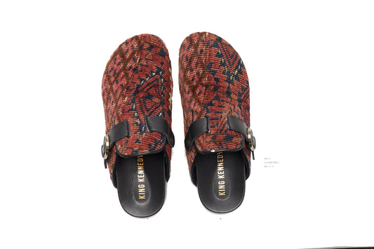 King Kennedy Rug Mules are one-of-a-kind and made of 100 year old antique Persian rug fragments with soft lambskin footbed and comfortable rubber sole. This pair is made of an antique Persian rug with a beautifully faded red pink base and blue, cream and tan diamond shaped designs throughout. 