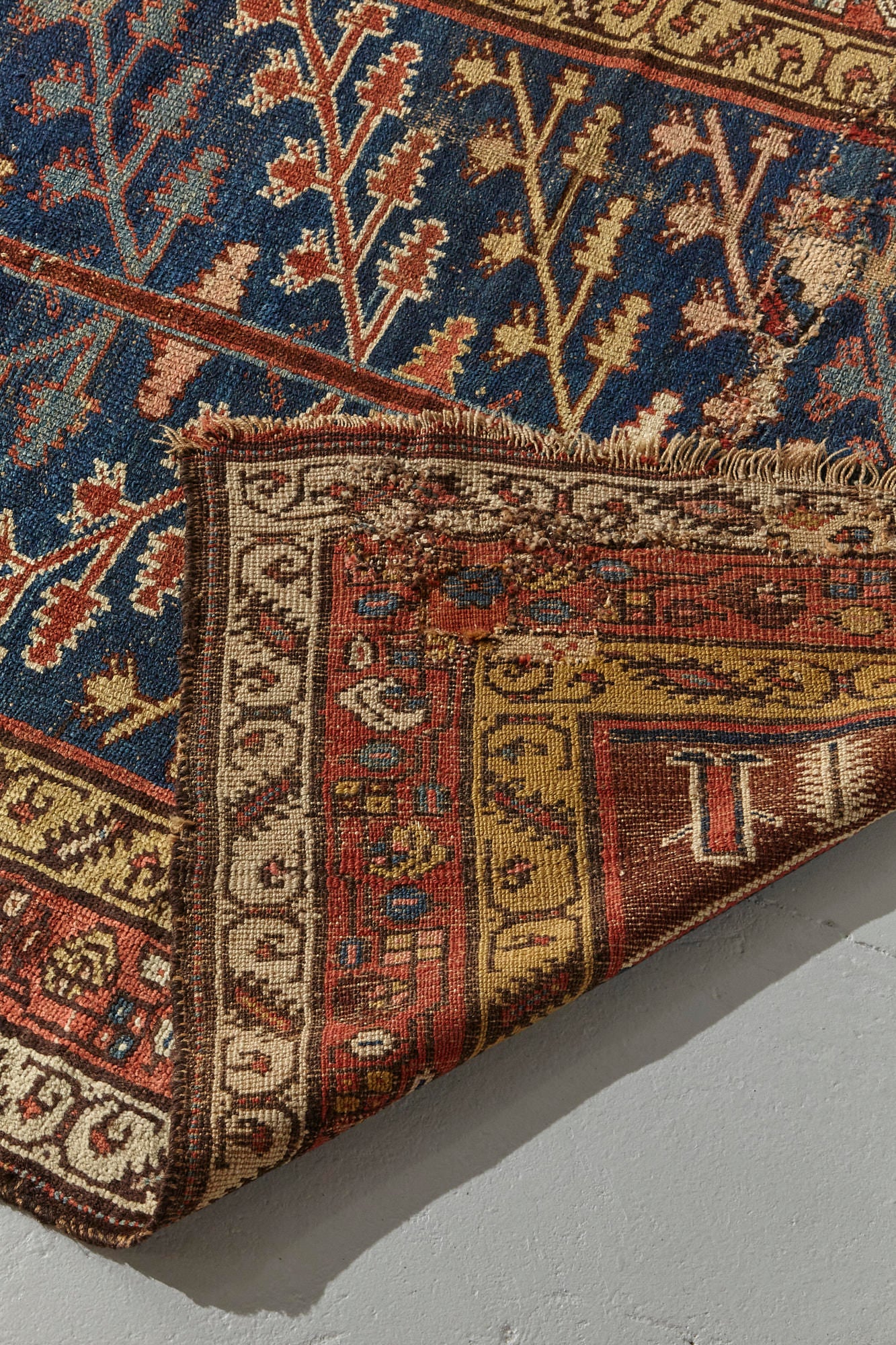 Front and back of Kurdish antique Persian rug, hand woven with tree of life design on a blue background with gold, red, pink and cream branch and leaf designs throughout, would be beautiful in a bedroom, kitchen, hallway or living room - Available from King Kennedy Rugs Los Angeles