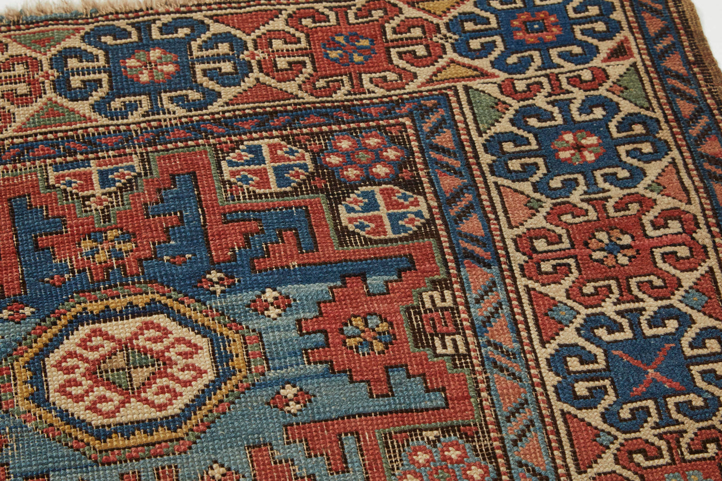Antique hand woven Lesghi star Persian Rug - intricately woven with blue, red, cream and green colors and three large star medallions in the center - Available from King Kennedy Rugs Los Angeles