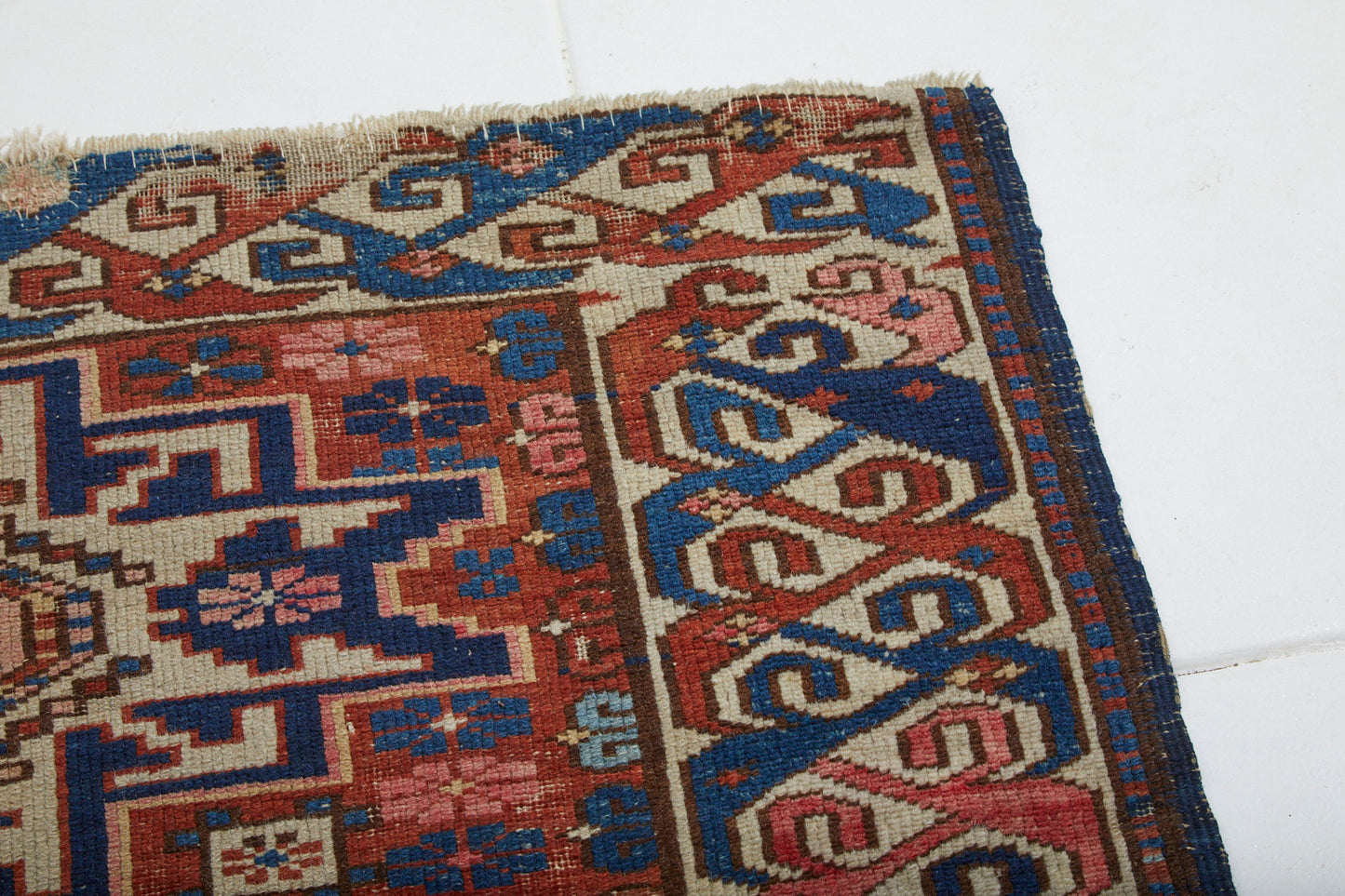 Antique hand woven Persian rug with cream and blue star and flower shapes on red base - Available from King Kennedy Rugs Los Angeles
