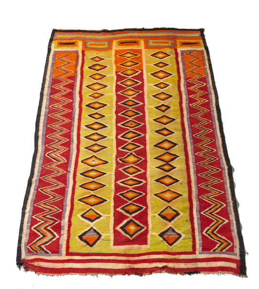 This Navajo Pound Blanket Transitional is a hand woven antique piece in vibrant red, orange and yellow natural dyes, with zig zags and diamonds throughout - Available from King Kennedy Rugs Los Angeles
