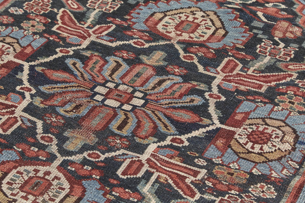 Detail of weave of antique Persian Bakhtiari hand woven rug with blue, red and cream floral design. Perfect for dining room, living room or office. Available from King Kennedy Rugs Los Angeles