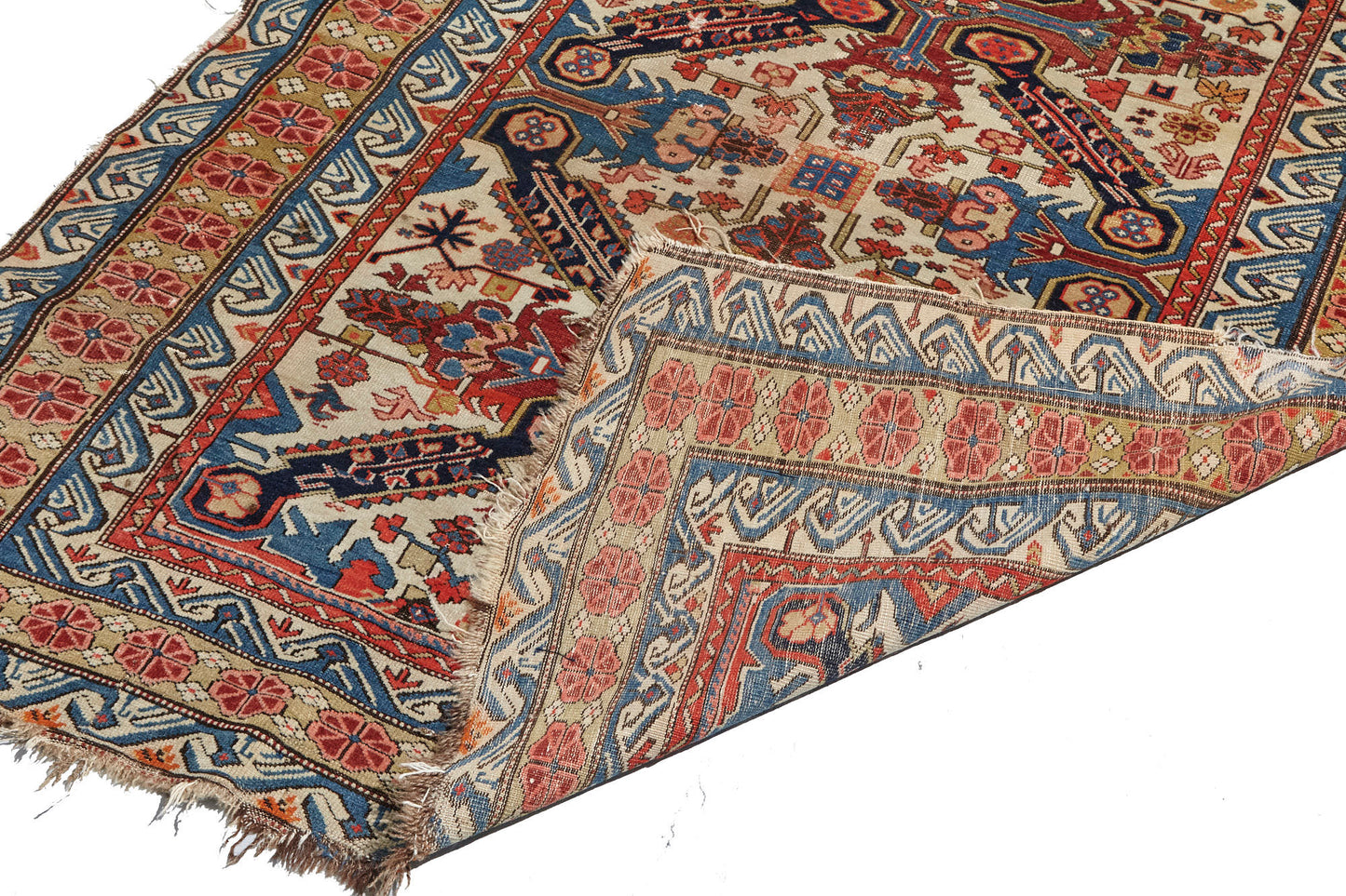 Front and back of intricately woven Zeychour Persian rug. Vibrant red and deep blue medallions with floral motifs throughout and border with red flowers and blue and white wave pattern. Available from King Kennedy Rugs Los Angeles