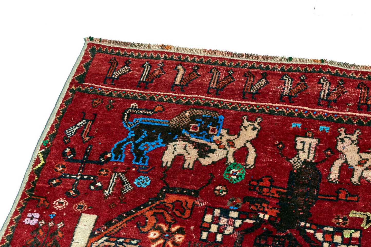 Unique and rare Persian pictorial hand woven rug with red base depicting a man wrestling a lion. Vibrant red and blue tones with cream, green and tan details. Perfect for study, living room, or wall hanging. Available from King Kennedy Rugs Los Angeles