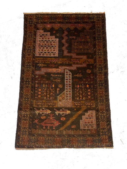 Hand woven Afghan war rug with buildings, planes and helicopters. Hand woven in deep brown with cream, red and orange details. Perfect for a study, kitchen or bedroom. Available from King Kennedy Rugs Los Angeles