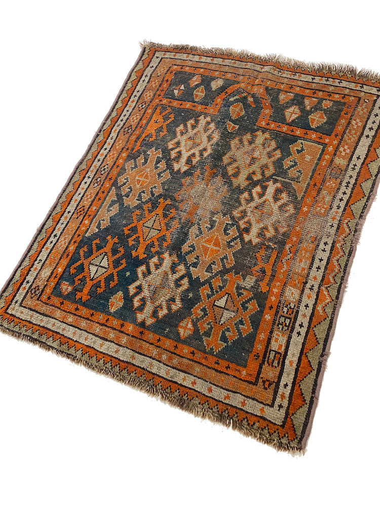 Hand woven antique Shirvan Persian Prayer Rug with blue base and orange, cream colored designs throughout - Available from King Kennedy Rugs Los Angeles 