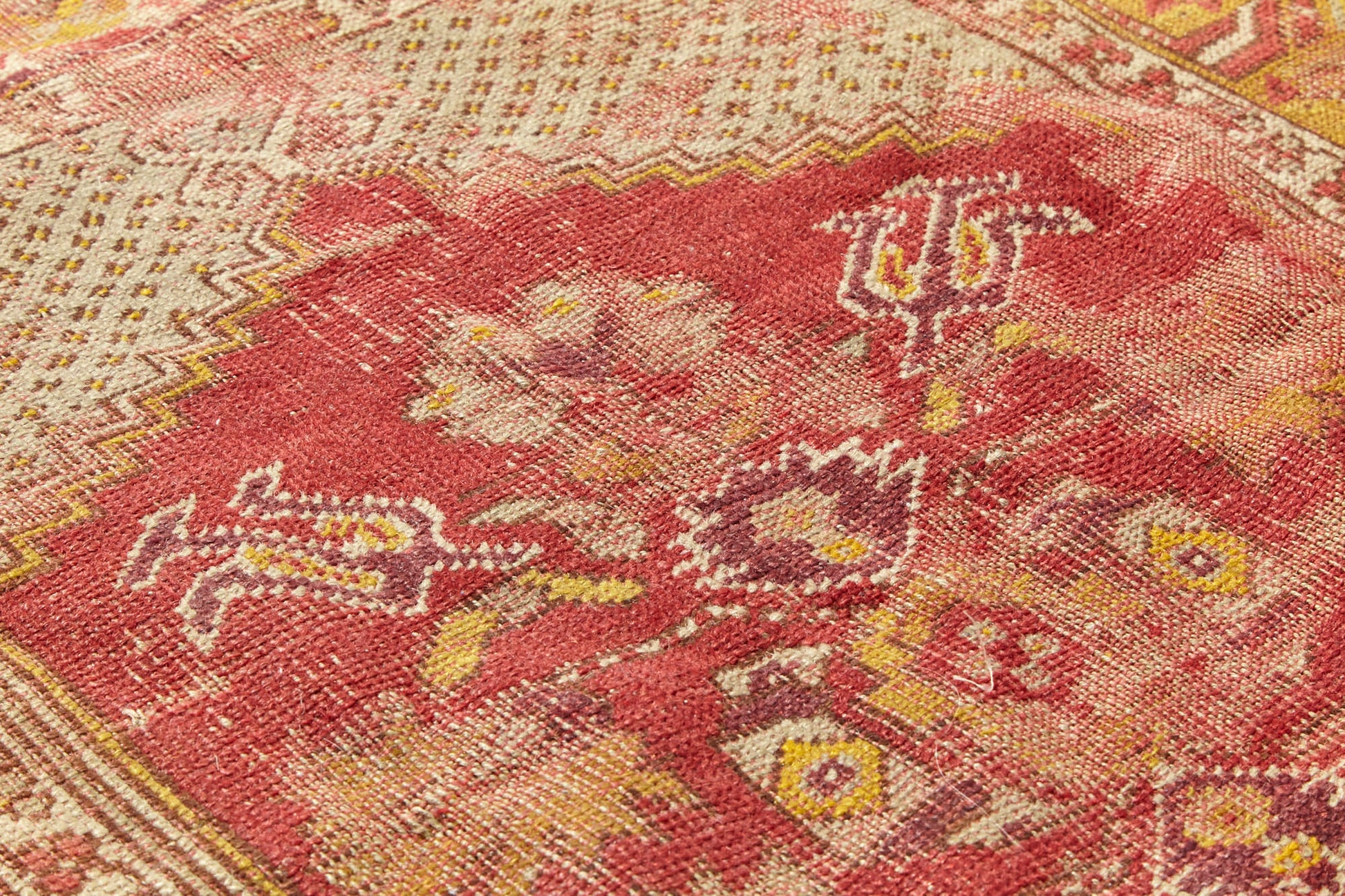 Detail of antique Turkish Prayer Rug, hand woven in red and gold, perfect for a bed room, study or kitchen rug - Available from King Kennedy Rugs Los Angeles