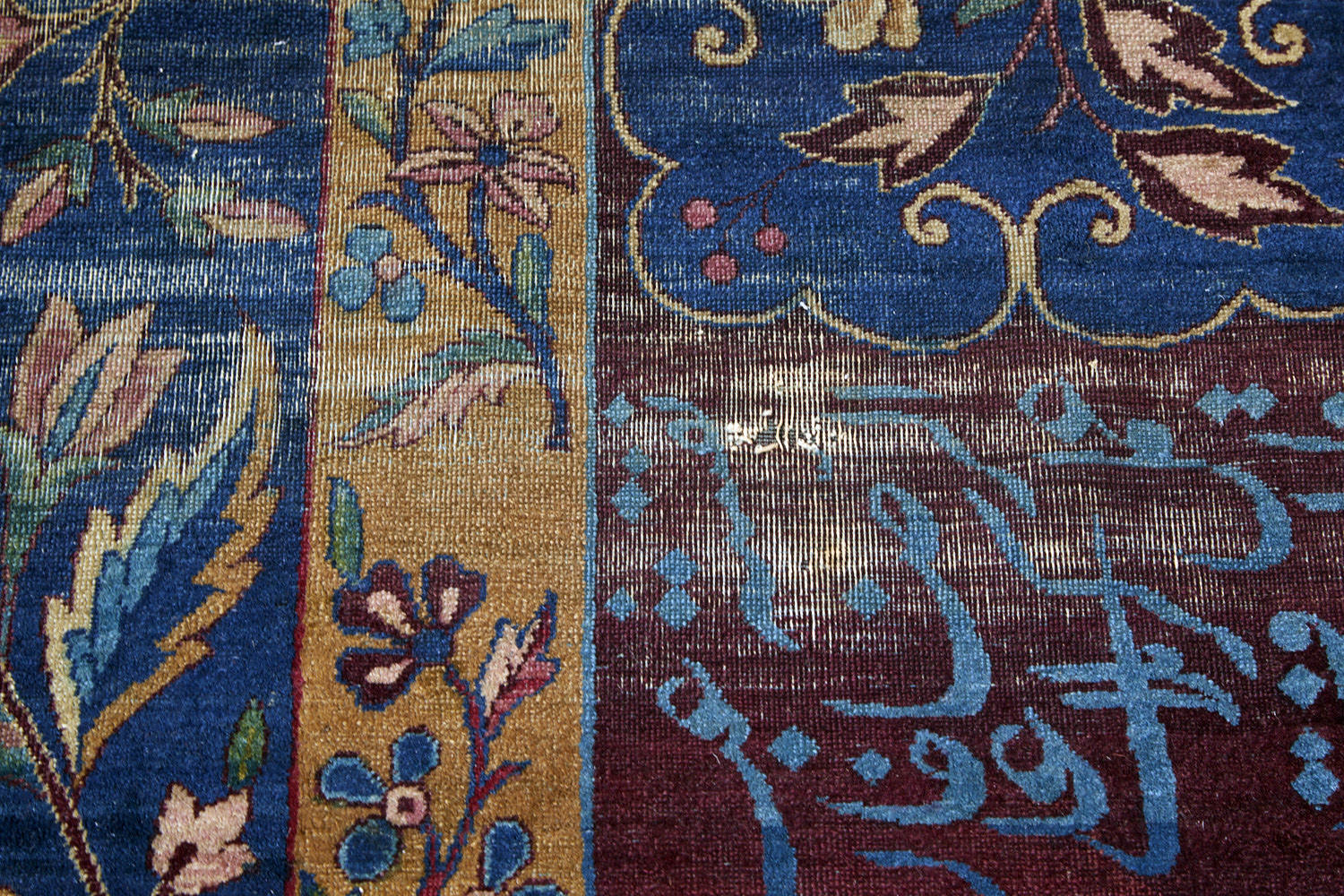 Blue Persian rug with gold and burgandy floral patterns and Arabic writing in the border, handwoven antique area rug - Available from King Kennedy Rugs Los Angeles